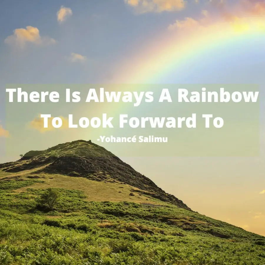 positive words over a hill with a rainbow